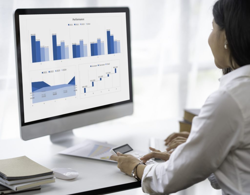 two young Asian businesswomen using their documents and calculators to plan marketing strategies and investments to profit from their clients,finance and calculate concept