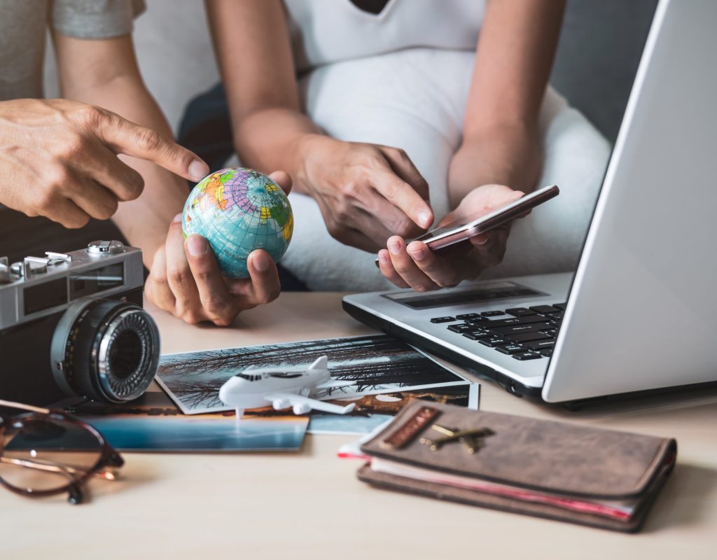 Young couple planning vacation trip and searching information or booking hotel on a smart phone